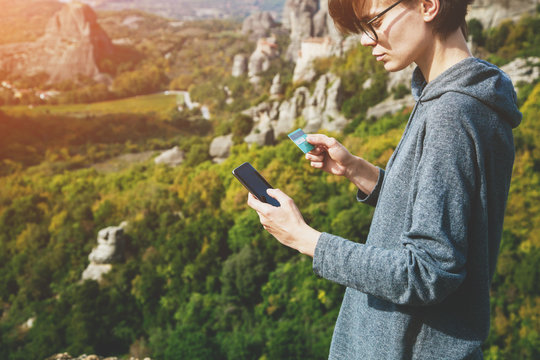 online payment, young woman holding credit card and touching on smartphone screen, copy space