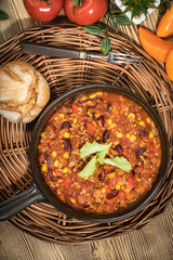 Chili con carne in a clay pan.