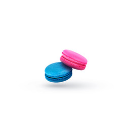 Blue and pink macaroon cookies in motion falling on a white background. Sweet and colorful french pasta falling or flying in motion.