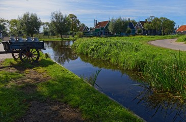 Fototapeta premium Carriage with milk at rural area