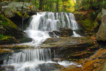 New England waterfall. Cascading waterfall in the forest during autumn season