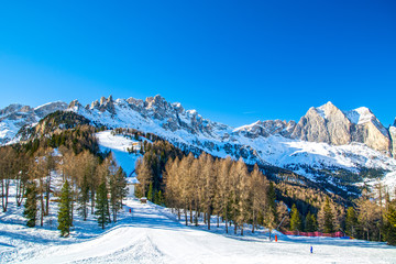 Fototapeta na wymiar Dolomites mountainski slope in Vigo di Fassa resort, Fassa valley area, Italy