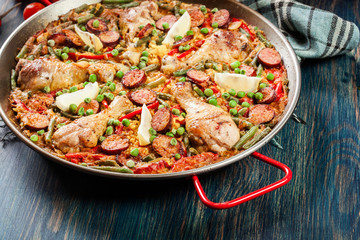Traditional paella with chicken legs, sausage chorizo and vegeta
