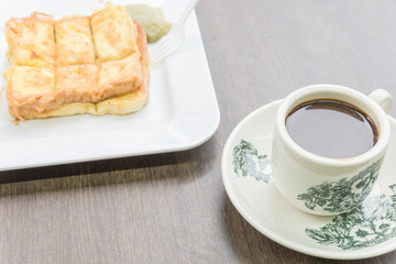 Delicious Kaya toast with jam and kopitiam coffee mug in traditional Chinese breakfast