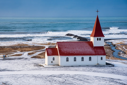 The Vik I Myrdal  church at the top of the hill offering picturesque images of the atlantic ocean and the village of vik in Iceland