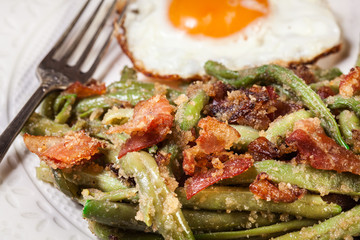 Healthy sauteed green beans with bacon and fried egg