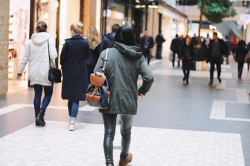 Obraz premium Rear view of a hipster girl with a backpack on her back
