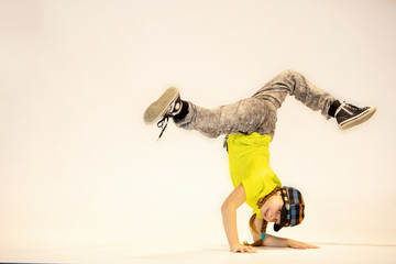 a little girl performs breakdance, a child in a unique acrobatic dance pose,bgirl in action