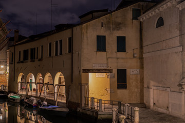 narrow street and beautiful arches near a picturesque water canal in venice italy