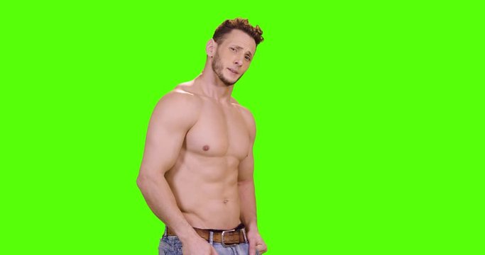 Handsome shirtless model reacts In various gestures to the camera. Medium shot over green screen.