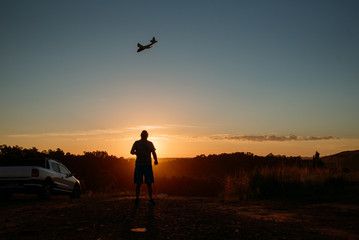 Fototapeta na wymiar man with airplane at sunset