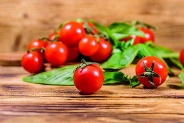 Heap of small cherry tomatoes on wooden table