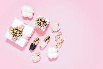Valentine's Day concept, 8 march, woman's flat lay with gift box, golden bow, ribbon, earrings, polish gel, cotton flowers, hearts on pink backdrop. Time for love and greetings. Copy space. 