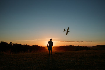 man with airplane at sunset