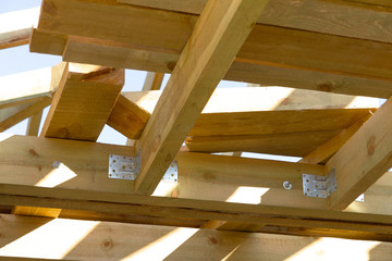 Close-up detail of wooden high steep roof framing under construction