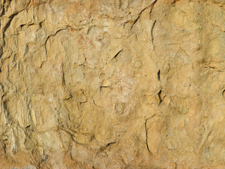 Texture of old cracked stone wall. Brown rough surface.