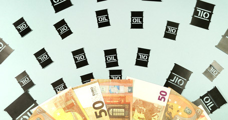 Fototapeta premium Paper application oil barrels on a background of euro banknotes money.