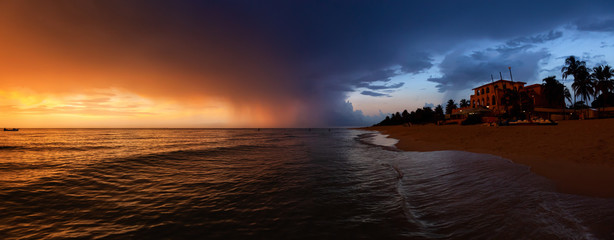 Beautiful panoramic view of vacation resort on the sandy beach during a dramatic cloudy sunset. Taken in Varadero, Cuba.