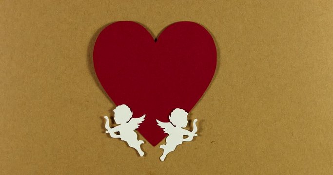 Cupids on a background of hearts shots trigger a flight of butterflies Valentine's Day concept