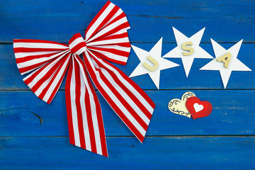 Fototapeta na wymiar Red and white bow with USA, stars and hearts on background; American design 