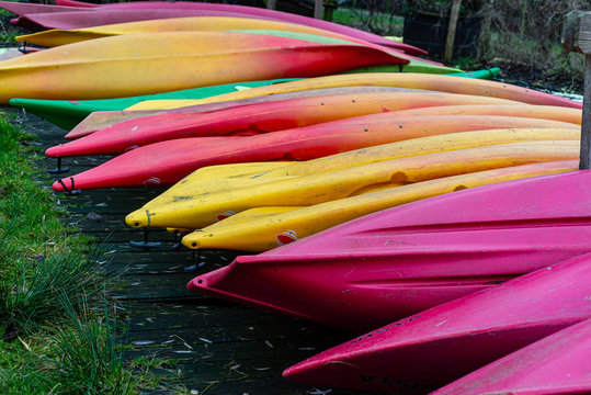 Group of canoes and rental kayak on the canal shore in Zoeterwoude, Leiden, Netherlands