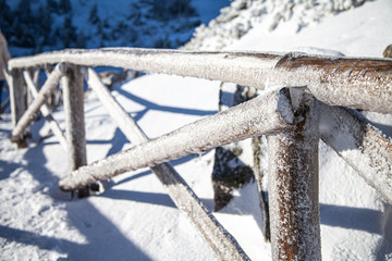 zimowy most drewniany w górach pokryty lodem i śniegiem © andsko
