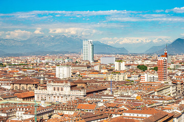 Fototapeta premium Aerial PAnoramic summer view on Turin skyline, with the city center, Po river, Mole Antonelliana, modern skyscrapers and other landmark seen from viewpoint the Monte dei Cappuccini on snowy alps Italy