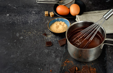 A pot with hot chocolate on dark background