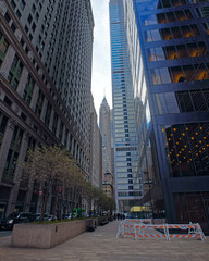 Street in Financial District at Lower and Downtown Manhattan, New York of USA. Skyline and cityscape with skyscrapers at United States of America, NYC, US. Road and American architecture.