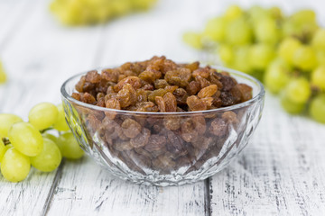 Portion of healthy Raisins (selective focus; close-up shot)