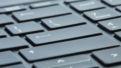 Gray laptop keyboard close-up. Selective focus on enter buttons. - 313708444