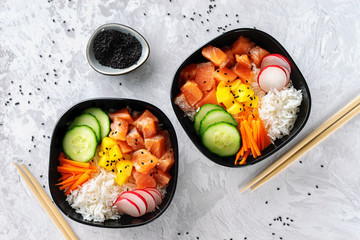 Close up of two poke bowls with salmon on white background