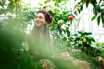 pretty islam woman in orange grove smiling, real muslim girl cheerful , nature organic people concept