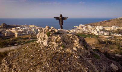 Rising 320 feet above sea level, a 6 meter tall statue of the resurrected Christ stands on top of Tas Salvatur Hill on Gozo in Malta.