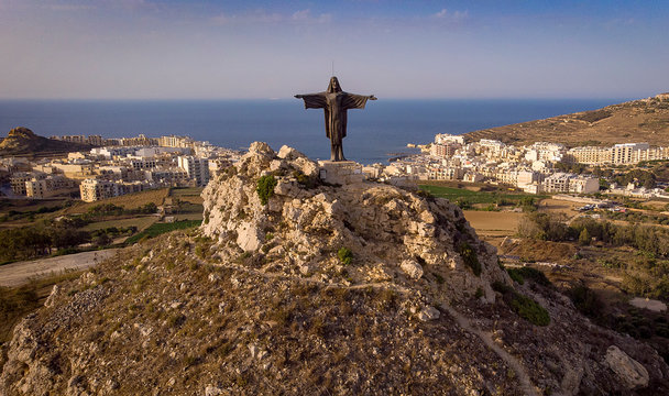 Rising 320 feet above sea level, a 6 meter tall statue of the resurrected Christ stands on top of Tas Salvatur Hill on Gozo in Malta.