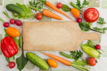 Vegetables and cutting board top view with copy space. Cooking vegan food concept