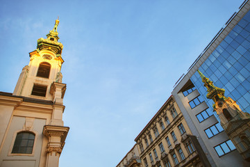 Fototapeta na wymiar reflection of church dome in the modern building windows