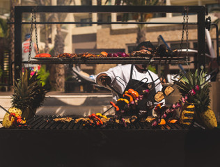 Naklejka premium Los Cabos, Baja California, Mexico - Oct 2019 Barbecue is a cooking method, techniques include smoking, roasting or baking, braising and grilling