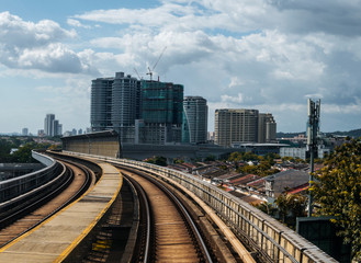 Public train track with view of skyscrapers. Transportation concept.