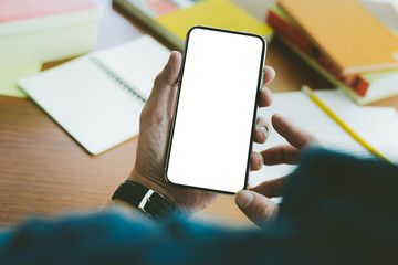 Mockup image blank white screen cell phone.man hand holding texting using mobile on desk at office.background empty space for advertise text.people contact marketing business,technology 