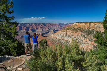 Couple enjoying the view of the Grand Canyon from Pipe Creek Vista, Arizona, USA