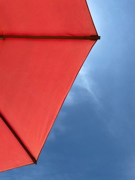 red umbrella on background of blue sky