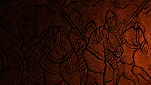 Medieval Soldiers Wall Carving In Fire Glow