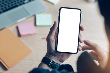 Mockup image blank white screen cell phone.man hand holding texting using mobile on desk at coffee shop.background empty space for advertise text.people contact marketing business,technology 