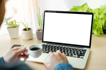Fototapeta premium mockup image blank screen computer with white background for advertising text,hand man using laptop contact business search information on desk at home office.marketing and creative design