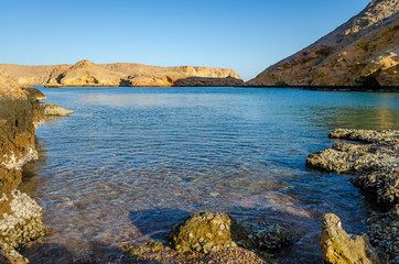 Tranquilizing view of a rocky beach in Muscat, Oman.