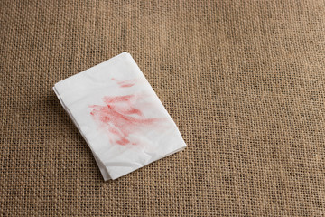 Red lipstick stain or smudges on white tissue paper