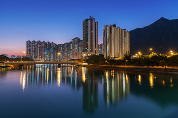 High rise residential building and mountain in Hong Kong city at dusk