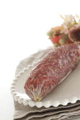 Italian food, salami on dish with copy space