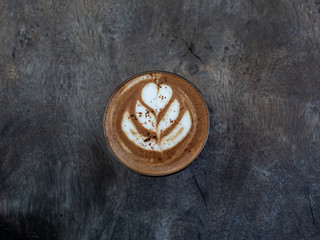 Mocha coffee on wooden table background.